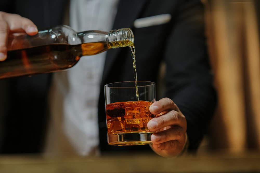 A man pouring whiskey