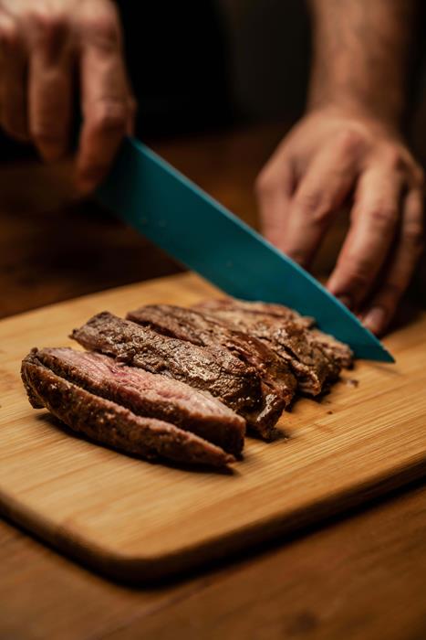 A person chopping steak