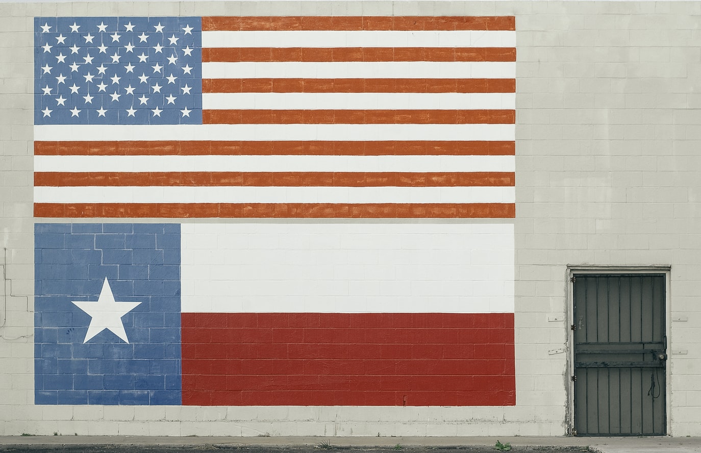 The flags of the United States of America and Texas painted on a wall