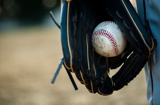 Close-up picture of gloves and baseball.