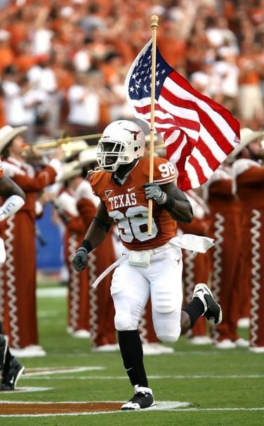nfl-player-holding-usa-flag-on-field