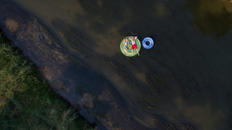 a couple tubing down the river