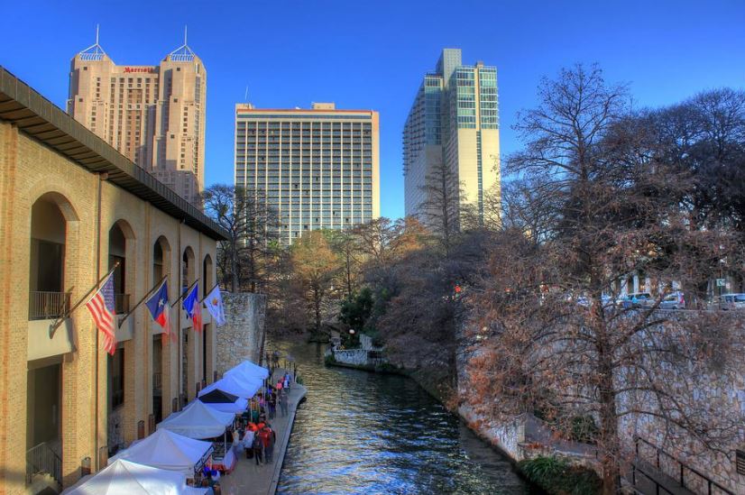 a lake and tall buildings in San Antonio, Texas
