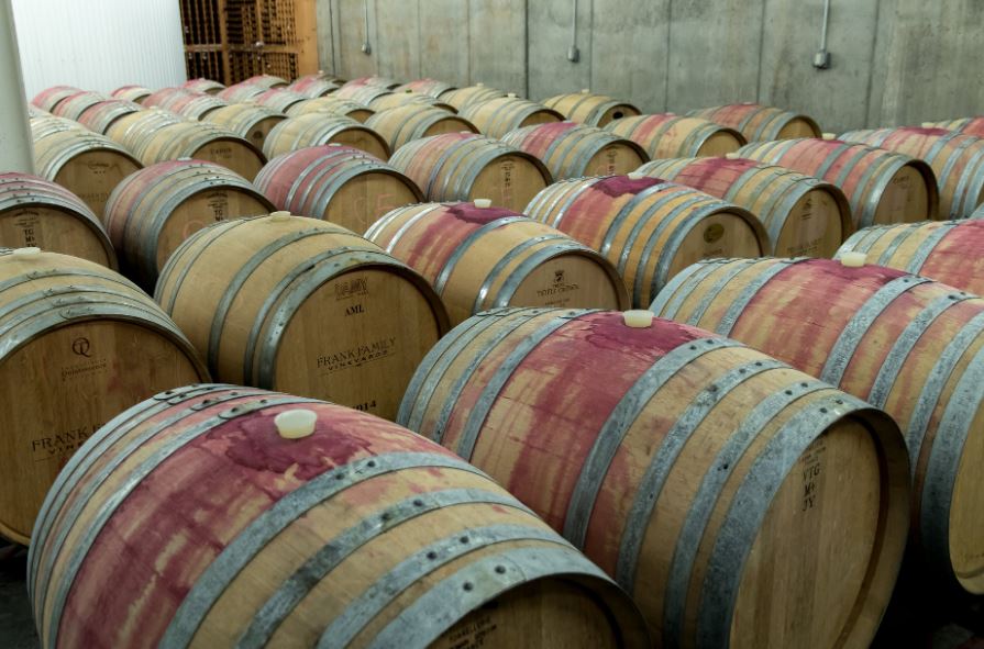 many wine barrels in a room