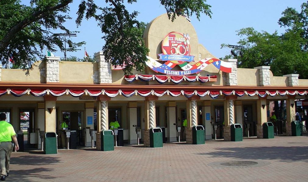 the main park entrance to Six Flags Over Texas showing their 50th Anniversary sign