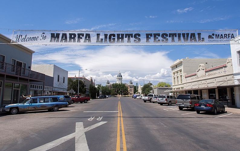 Downtown Marfa with a banner saying “Welcome to Marfa Lights Festival”