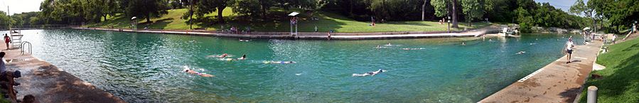 Panoramic of people swimming in the Barton Springs Pool