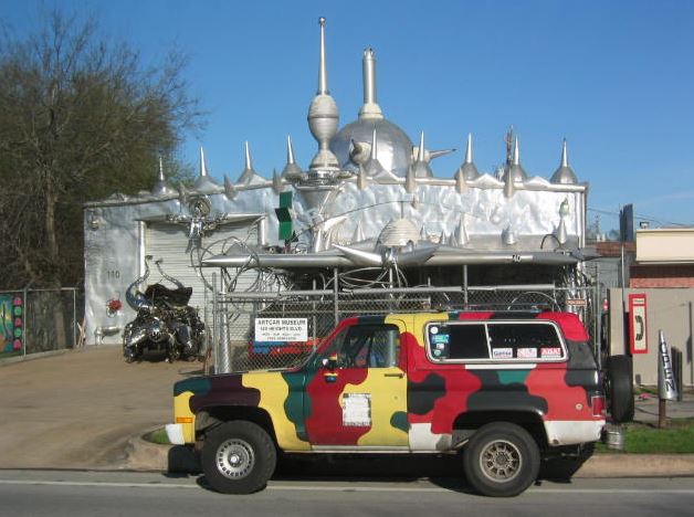 a colorful car parked in front of the Art Car Museum