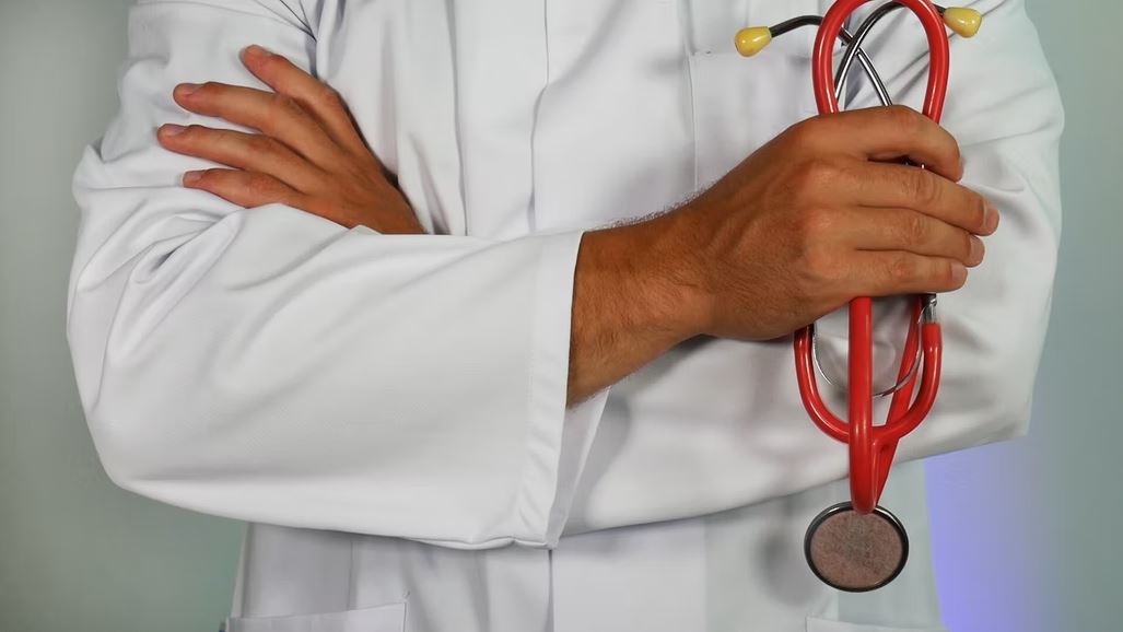 a doctor holding a red stethoscope