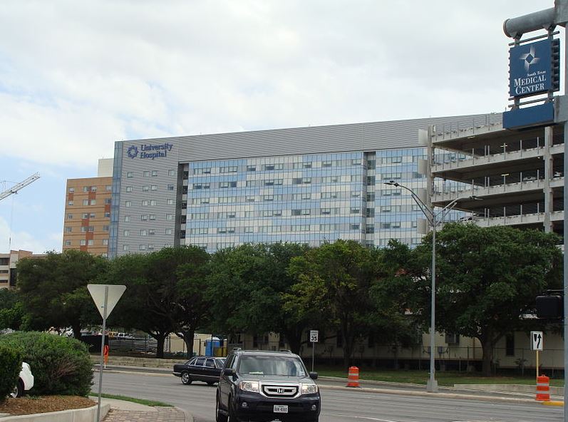 the outside of the University Hospital in San Antonio, cars passing by