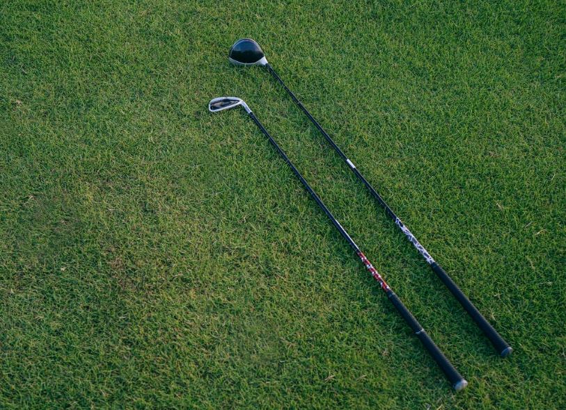 two golf clubs on the grass