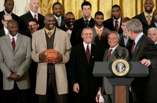 Shaq holding the championship ball while visiting the White House with the NBA Champion Miami Heat
