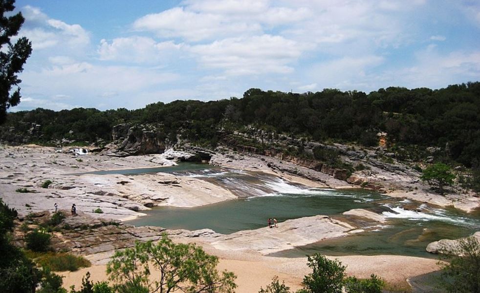 a wide view of the Pedernales Falls State Park with a few people