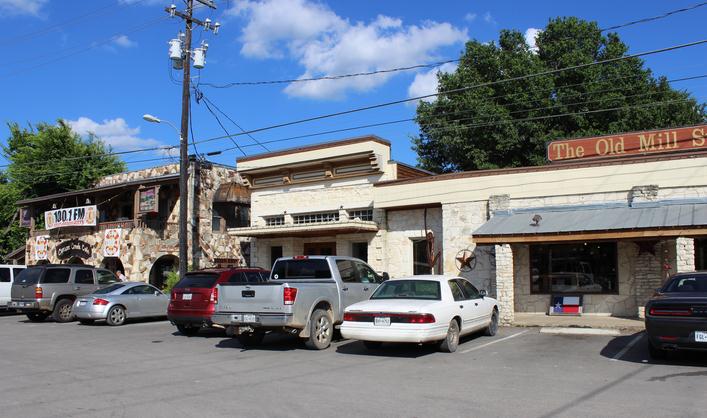 Downtown-Wimberley-brick-buildings-numerous-cars-parked-in-the-area