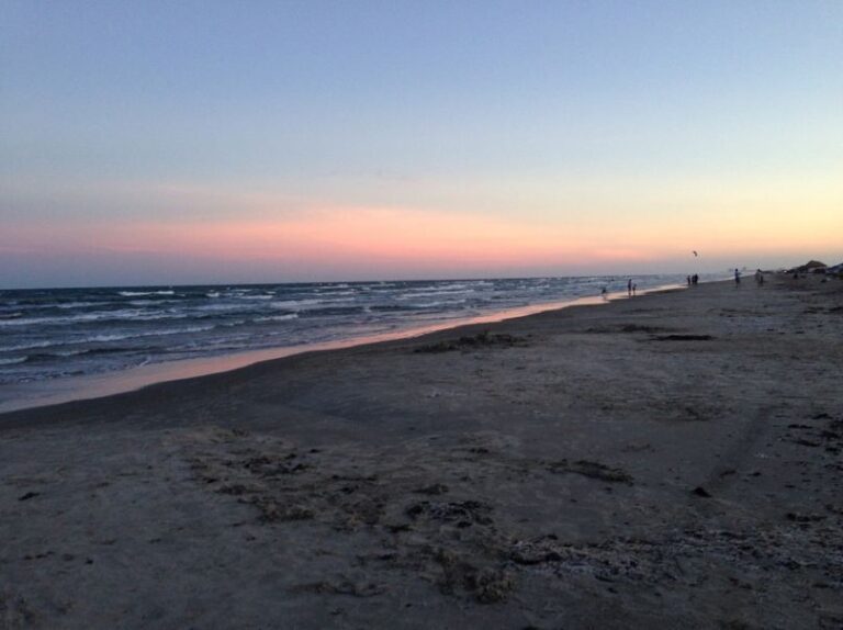 Port Aransas beach, seashore, people enjoying the beach, sea, waves, blue-pink sky