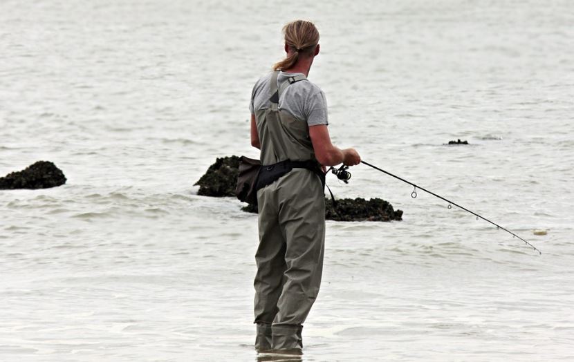 a man fishing at the beach