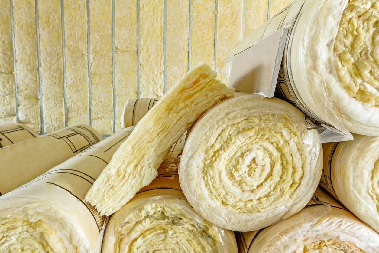 Stack of thermal insulation material in roll is wrapped