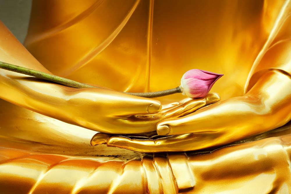 A Buddha image with lotus in hand