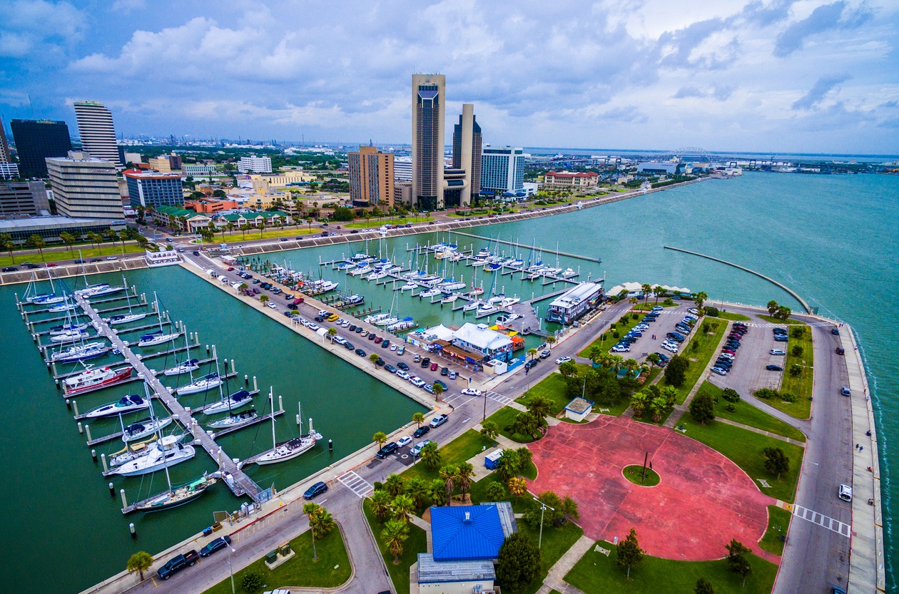 a marina in Corpus Christi, Texas with the cityscape on t he background