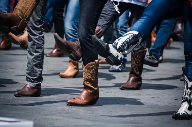 Cowboy boots of people line dancing