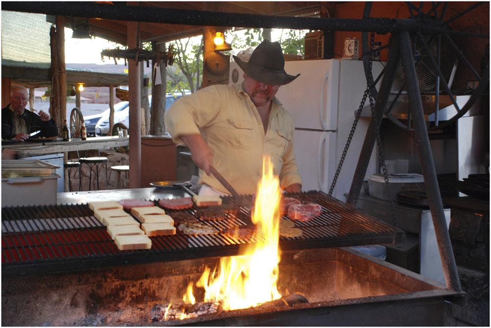 Steak and cook over burning flame in swinging BBQ