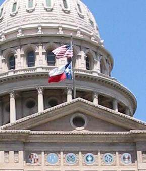 The U.S. and Texas flags at the Texas State Capitol