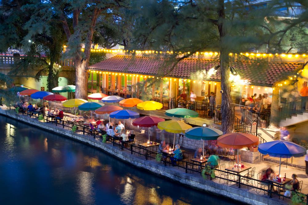 Tourist dining along the San Antonio River Walk in San Antonio, Texas