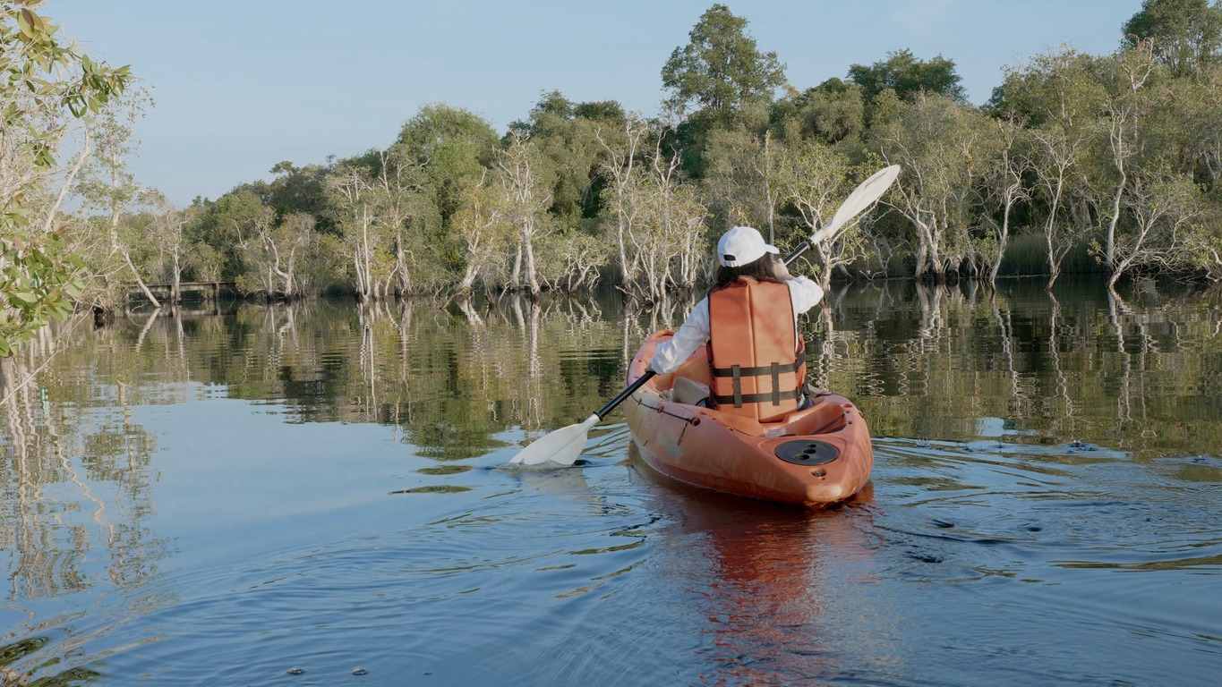 adult woman paddling canoe on a lake