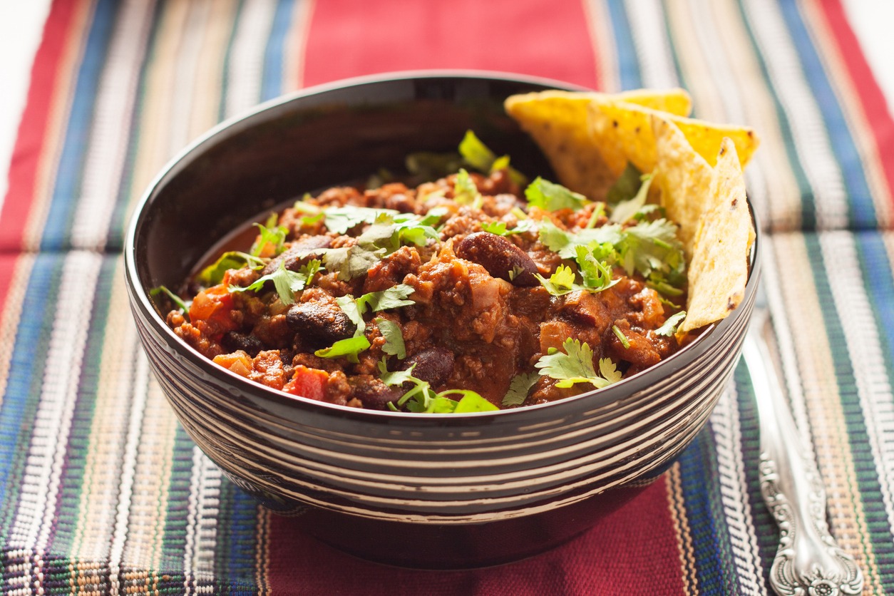 a bowl of chili con carne with tortilla chips