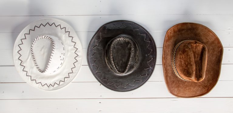 cowboy hats hanging on a wall