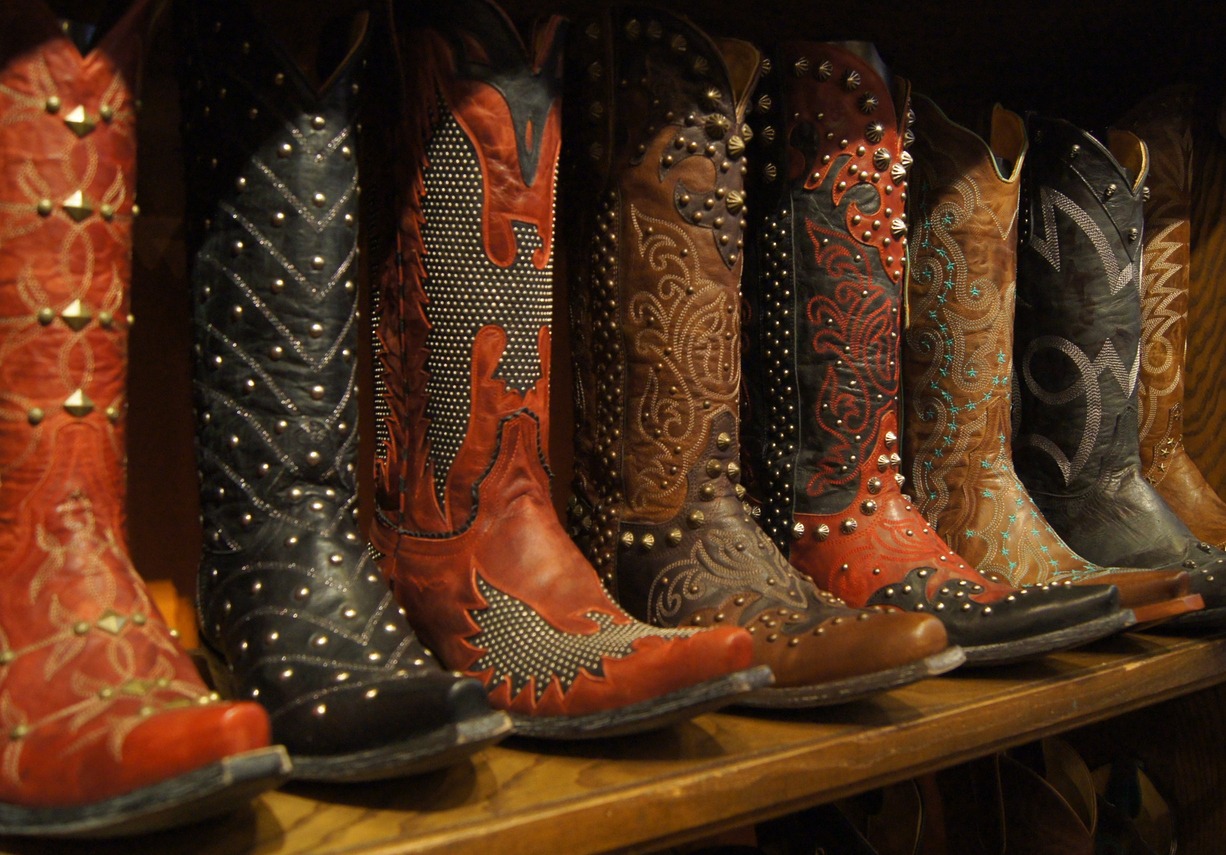 embellished western boots lined up on a shelf for display in Dallas, Texas, U.S.