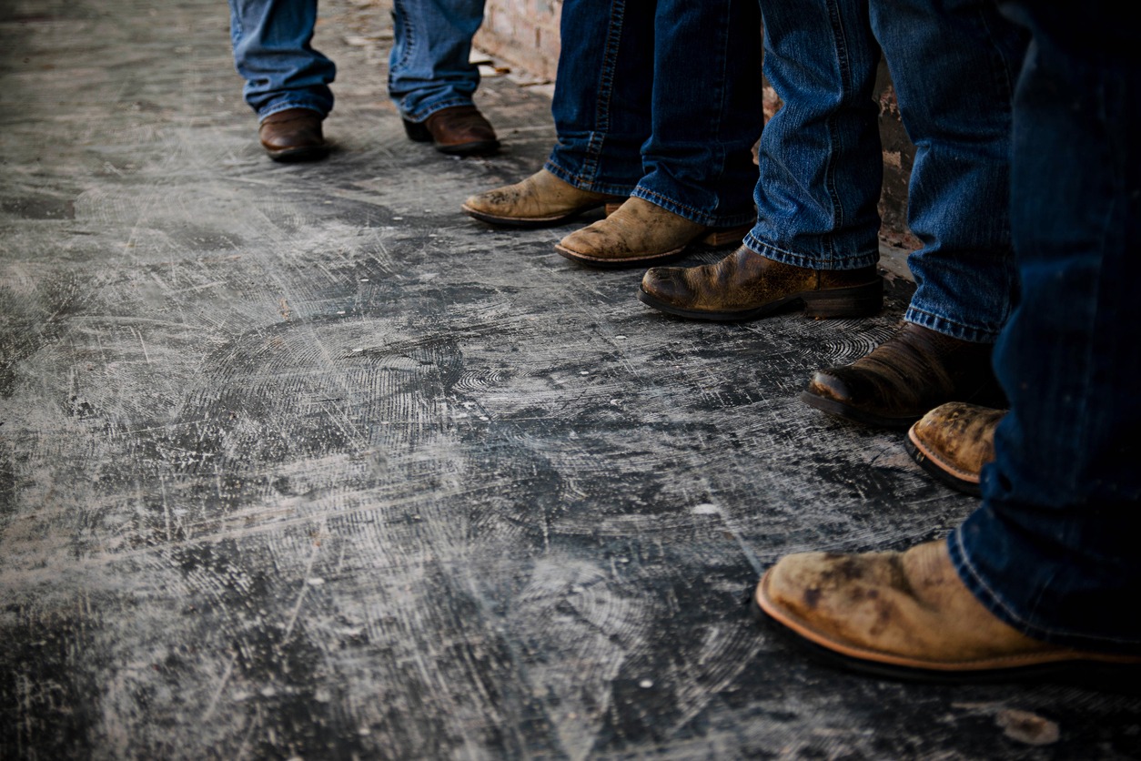 men all wearing jeans and cowboy boots