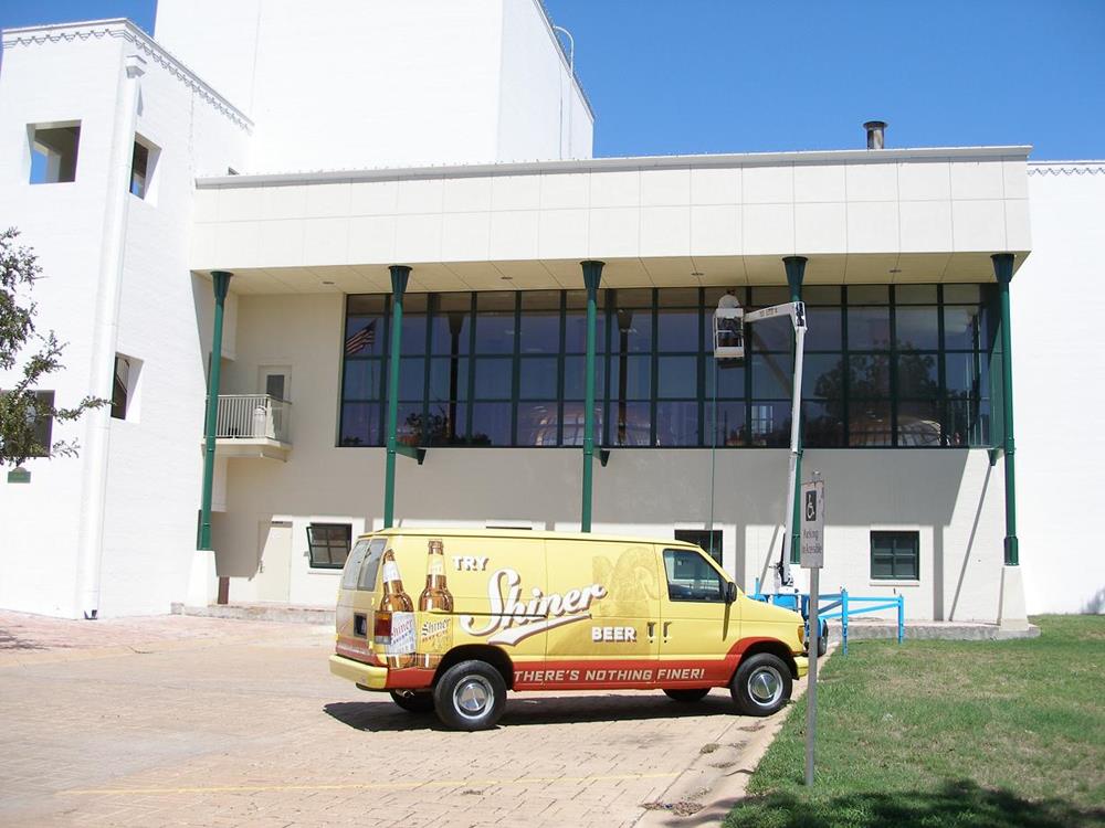 The Spoetzl brewery in Shiner, TX. with a car promoting Shiner beer